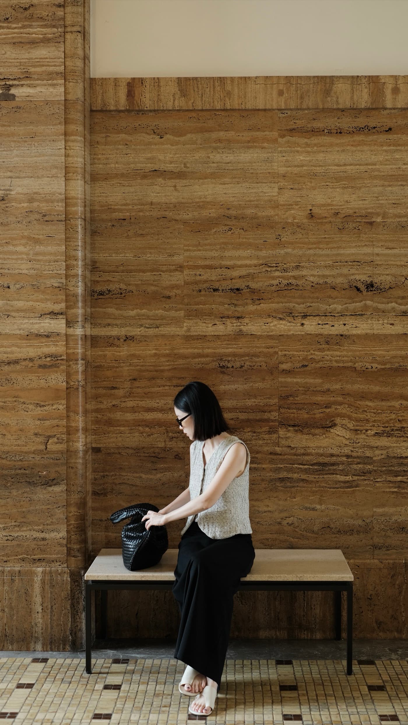Wentian sitting before a timber wall in Kyoto