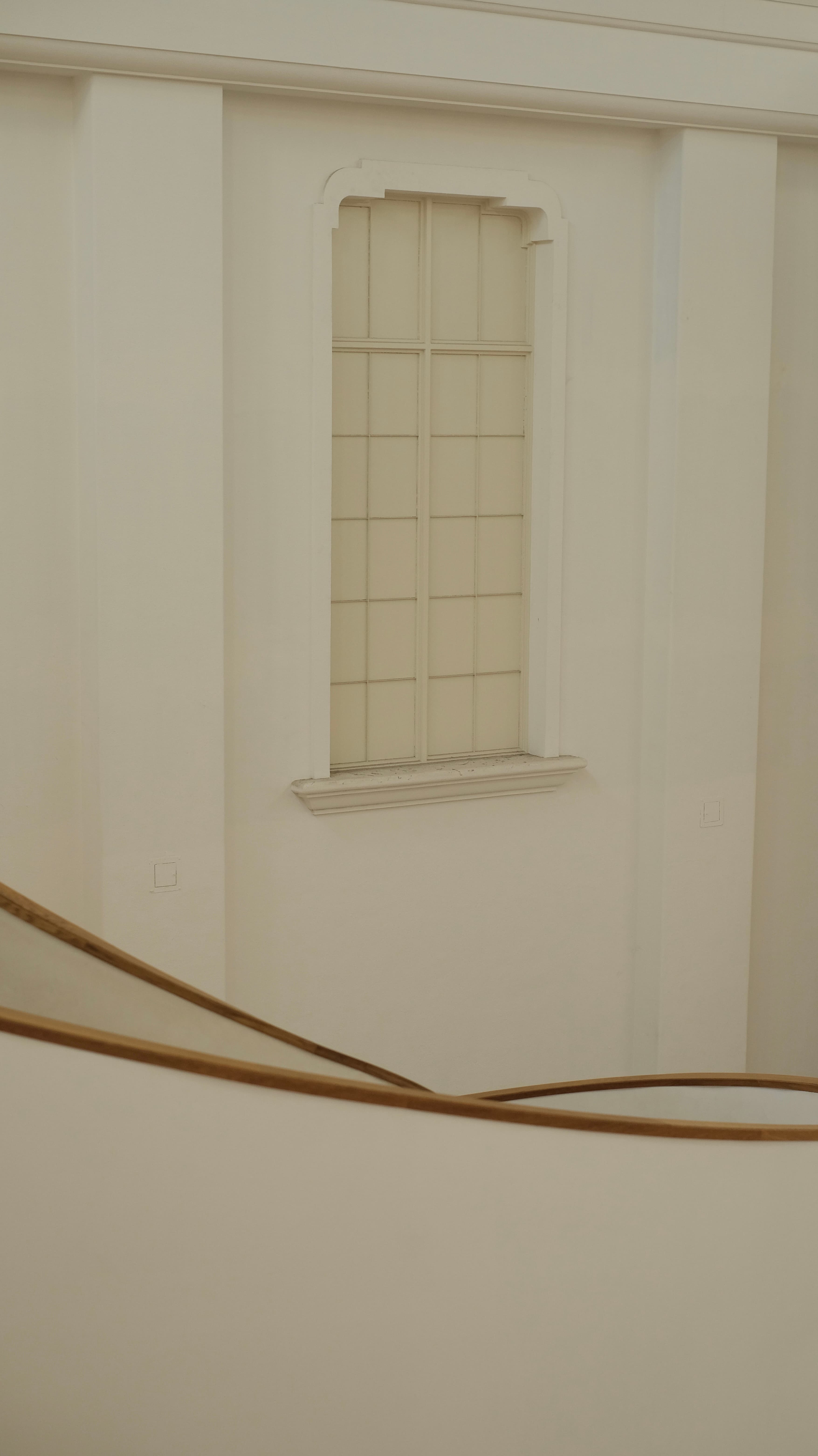 A warm white facade and narrow window in Kyoto